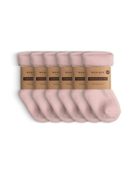 Set of six pairs of pink sherpa-style kids’ socks, wrapped in eco-friendly Menique kraft paper bands labeled ‘Premium Quality.