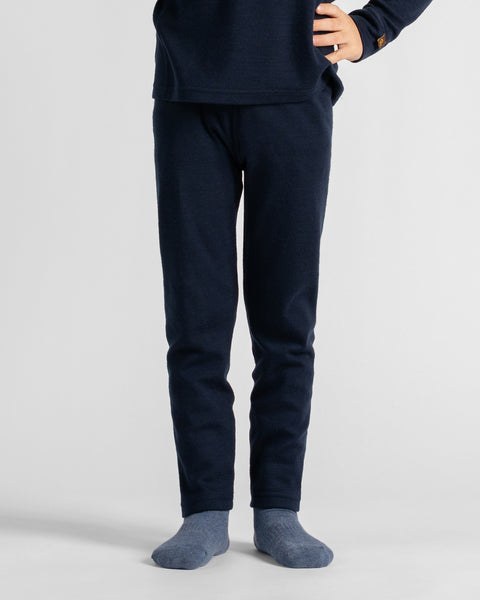 A cropped lower-body view showing dark navy lounge pants paired with blue patterned socks against a light gray backdrop.