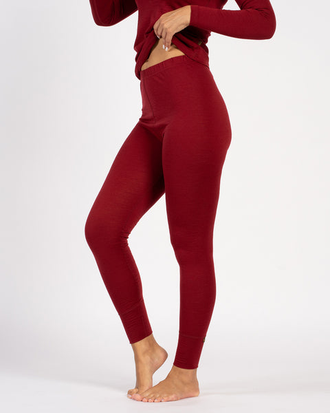 Side detail of royal cherry Merino wool thermal leggings, high-waist fit.