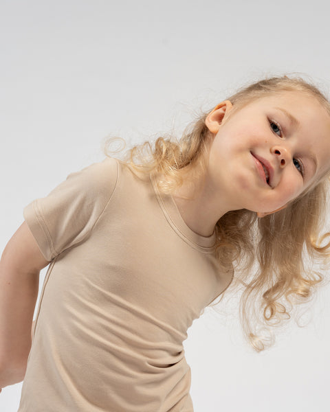 Girl in beige bamboo t-shirt and shorts – lightweight comfortable kids loungewear set