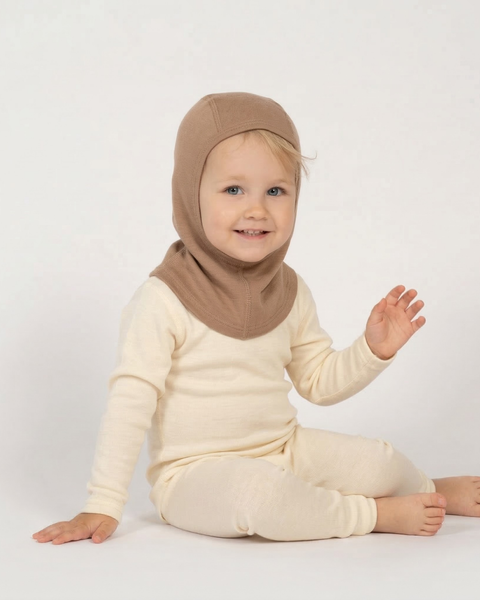 Toddler wearing beige merino wool balaclava and natural merino base layer, soft breathable kids merino wool balaclava designed for warmth, temperature regulation, and comfortable winter outdoor wear.