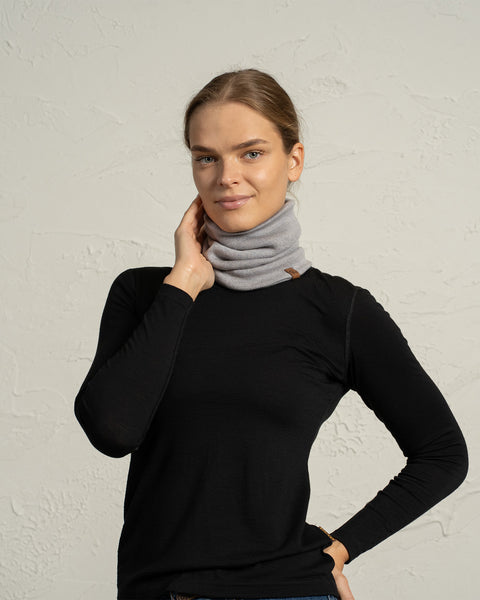 Woman in light gray Merino wool knit neck gaiter, warm and lightweight winter accessory.