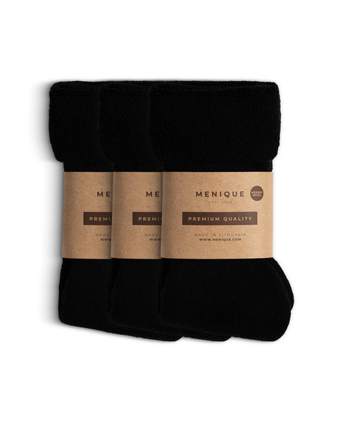 Set of three pairs of men’s black sherpa fleece socks, rolled and wrapped with Menique brown paper packaging labeled ‘Premium Quality – Merino Wool.