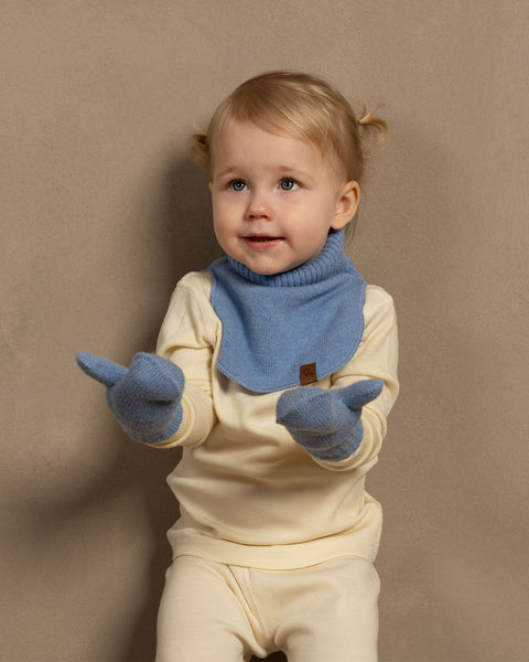 Little girl wearing merino wool long sleeve top and pants with knitter merino wool cashmere dickie and mittens in light blue