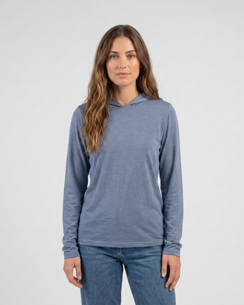 A women’s dusty blue lightweight hooded long sleeve shirt is shown from the front with a simple relaxed fit and soft fabric texture.